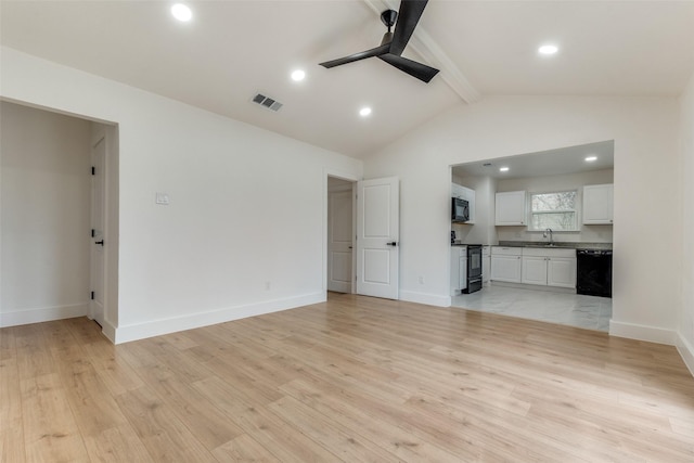 unfurnished living room with lofted ceiling with beams, sink, ceiling fan, and light hardwood / wood-style flooring