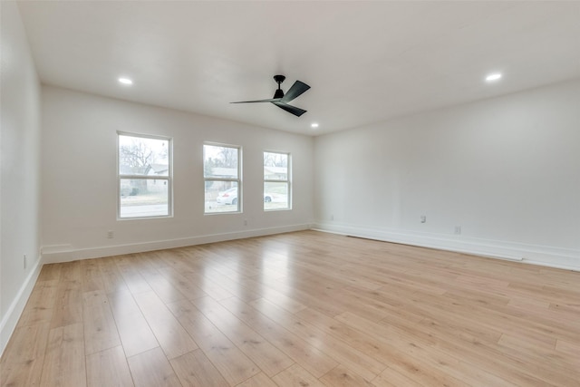 empty room with light hardwood / wood-style flooring and ceiling fan