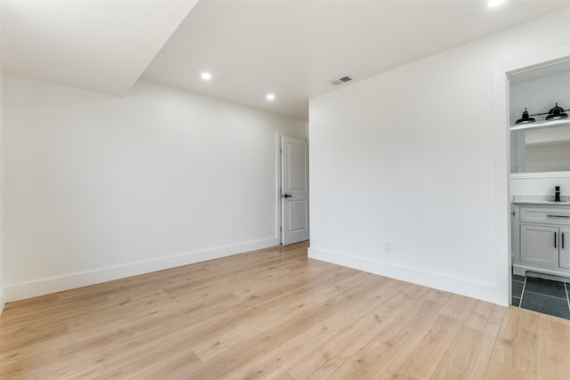 spare room with light hardwood / wood-style flooring