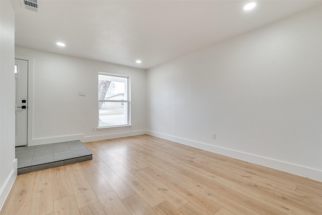 unfurnished room with light wood-type flooring