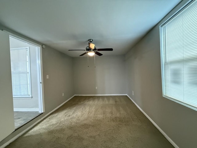 empty room with carpet flooring and ceiling fan