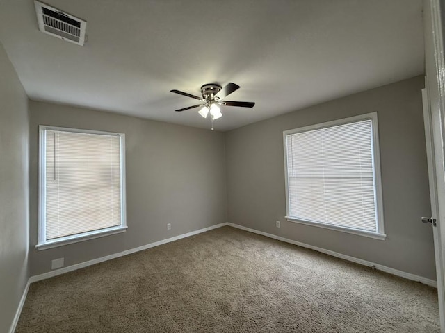 unfurnished room featuring a healthy amount of sunlight, carpet floors, and ceiling fan