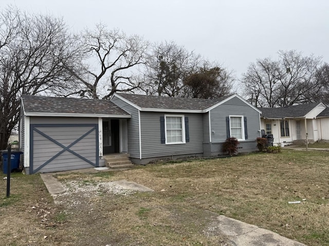 ranch-style house featuring a garage and a front yard