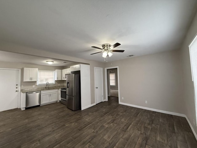 kitchen with white cabinetry, appliances with stainless steel finishes, dark wood-type flooring, and ceiling fan