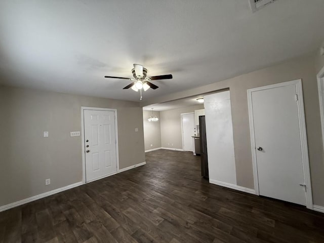 interior space featuring dark hardwood / wood-style floors and ceiling fan with notable chandelier