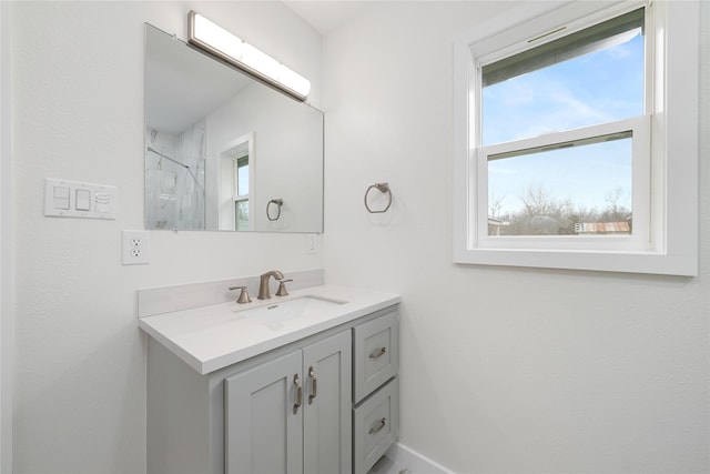 bathroom with walk in shower and vanity