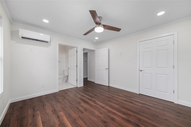 unfurnished bedroom featuring ensuite bathroom, a wall mounted air conditioner, ornamental molding, dark hardwood / wood-style flooring, and ceiling fan