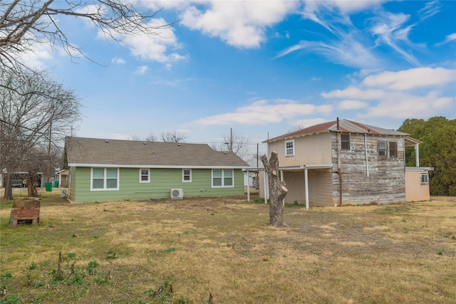 back of property featuring a lawn