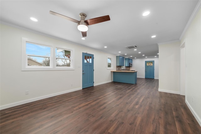 unfurnished living room with baseboards, visible vents, dark wood finished floors, recessed lighting, and ornamental molding