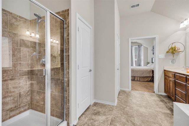 bathroom featuring lofted ceiling, an enclosed shower, and vanity