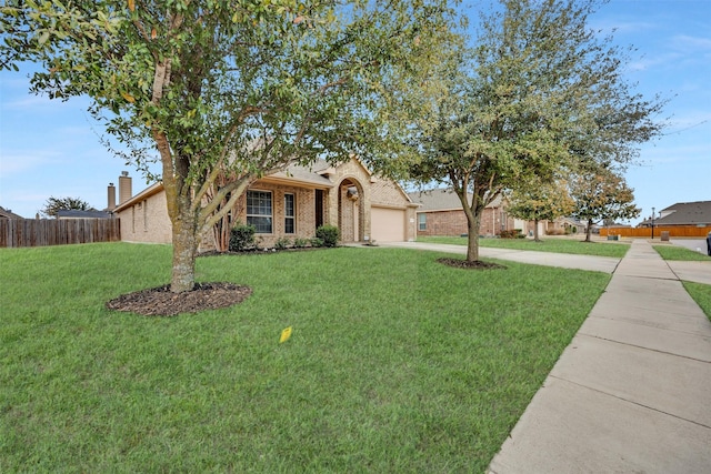 view of front of house with a garage and a front lawn