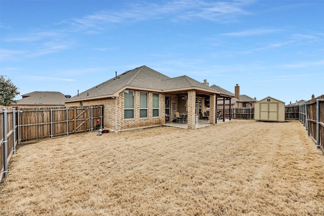 rear view of property featuring a storage unit and a patio