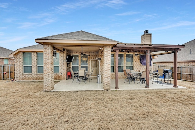 back of property with a patio and a lawn