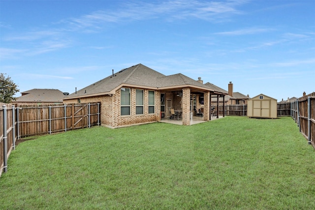 rear view of property featuring a storage shed, a patio, and a lawn