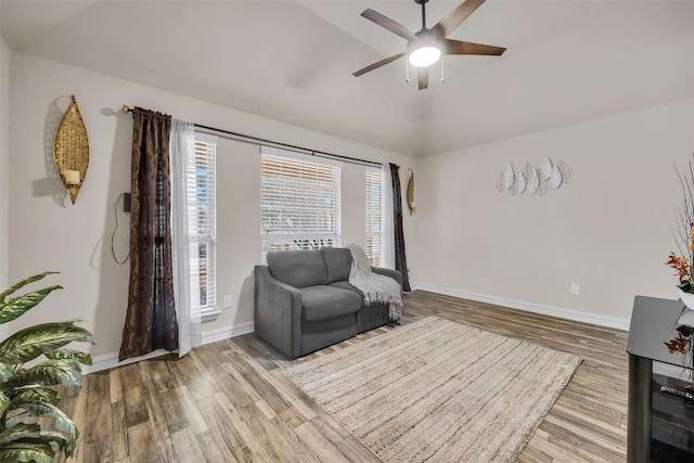 living area with lofted ceiling, wood-type flooring, and ceiling fan