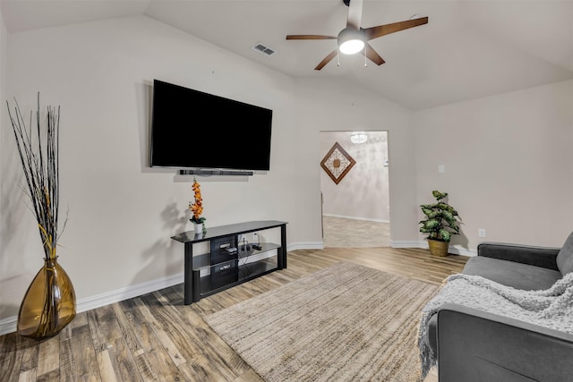 living room featuring ceiling fan, lofted ceiling, and light hardwood / wood-style flooring