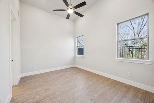 unfurnished room featuring ceiling fan, lofted ceiling, and light hardwood / wood-style flooring