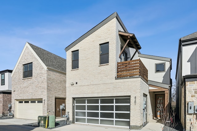 contemporary home featuring a garage, a balcony, and central air condition unit