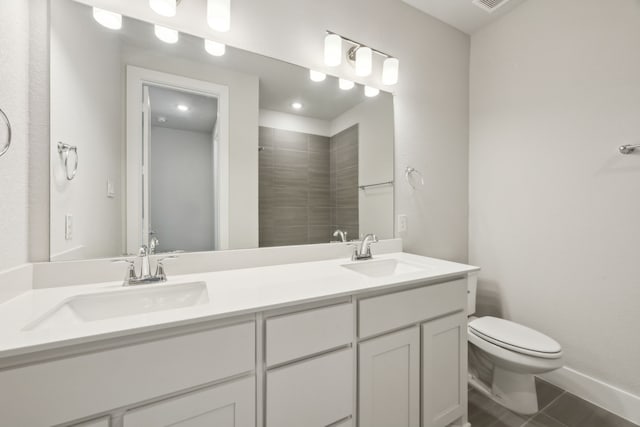 bathroom with vanity, a shower, tile patterned floors, and toilet