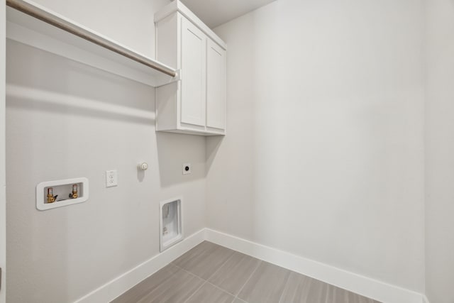 clothes washing area featuring gas dryer hookup, cabinets, hookup for a washing machine, and electric dryer hookup