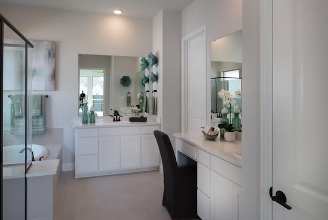 interior space with vanity and separate shower and tub