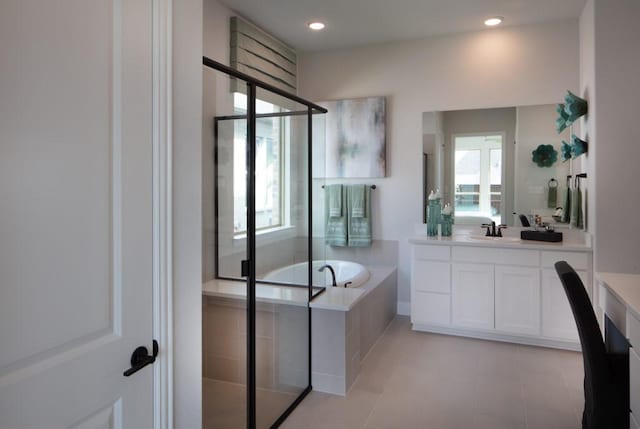 bathroom featuring shower with separate bathtub and vanity