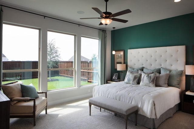 bedroom featuring light carpet and ceiling fan