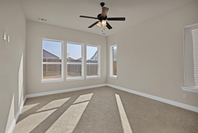 empty room with light carpet and ceiling fan