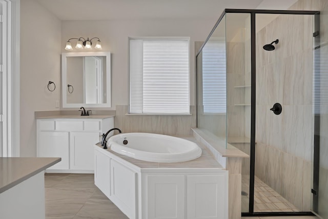 bathroom with vanity and separate shower and tub