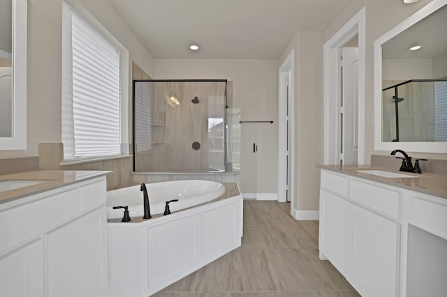 bathroom featuring vanity and separate shower and tub