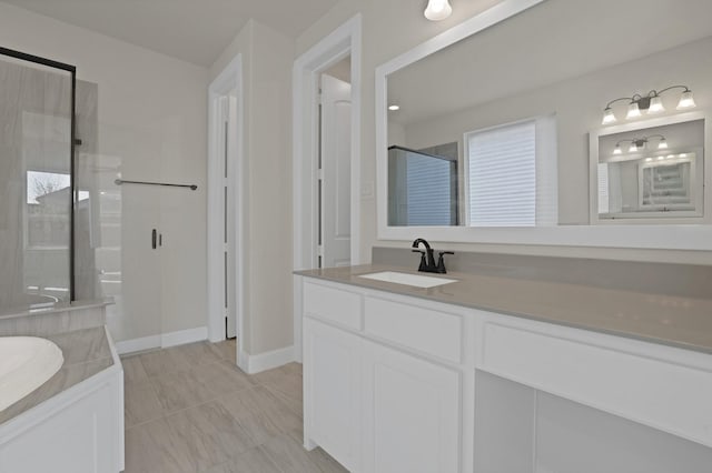 bathroom featuring a shower with door and vanity