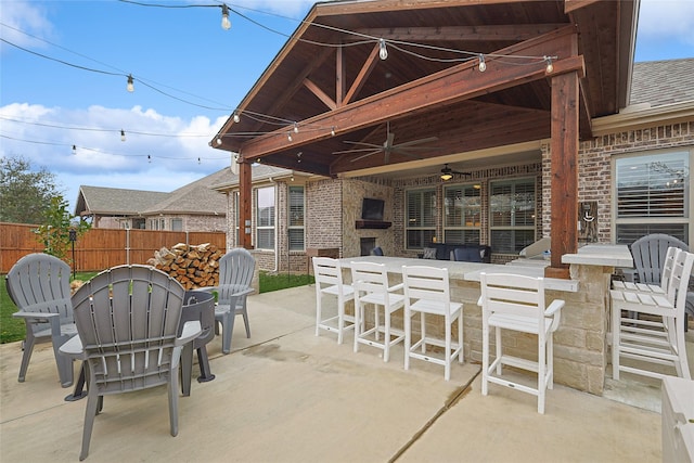 view of patio featuring exterior bar and ceiling fan