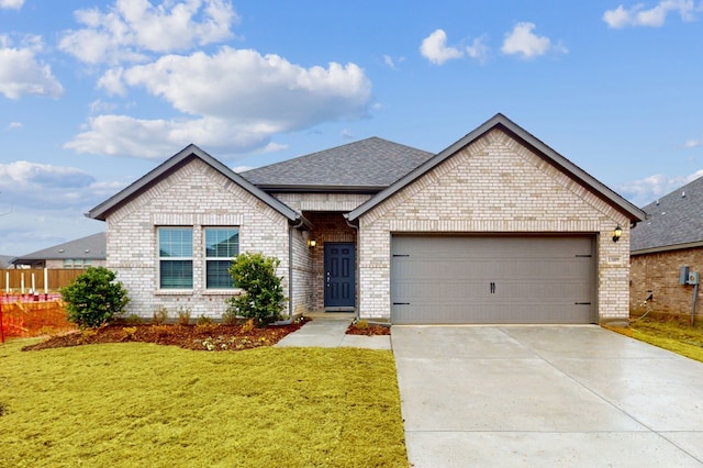 view of front of home featuring a garage and a front lawn