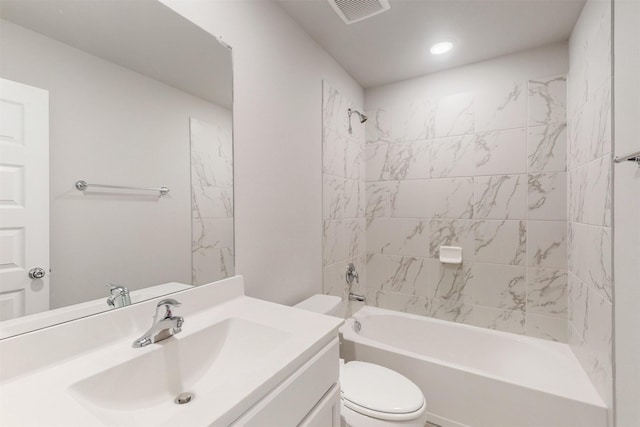 full bathroom with tiled shower / bath combo, vanity, and toilet