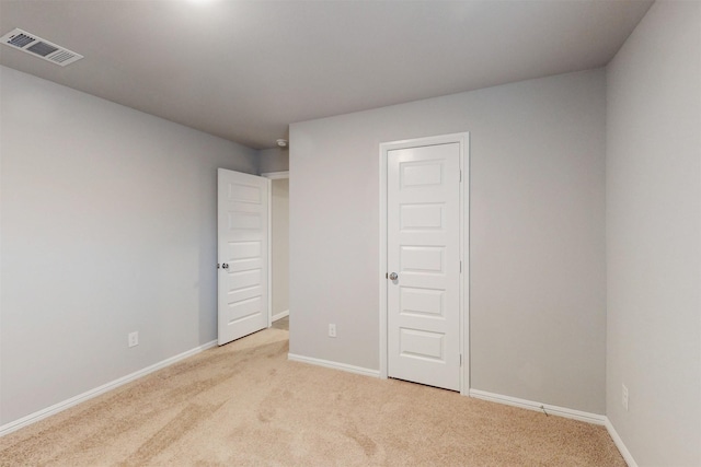 unfurnished bedroom featuring light colored carpet