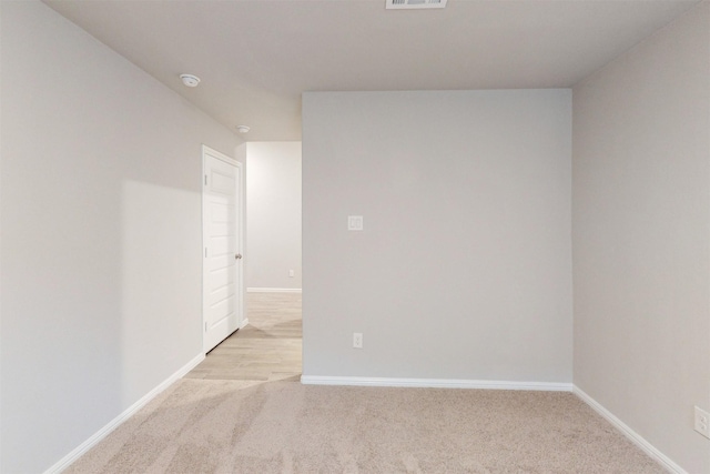 unfurnished room featuring light colored carpet