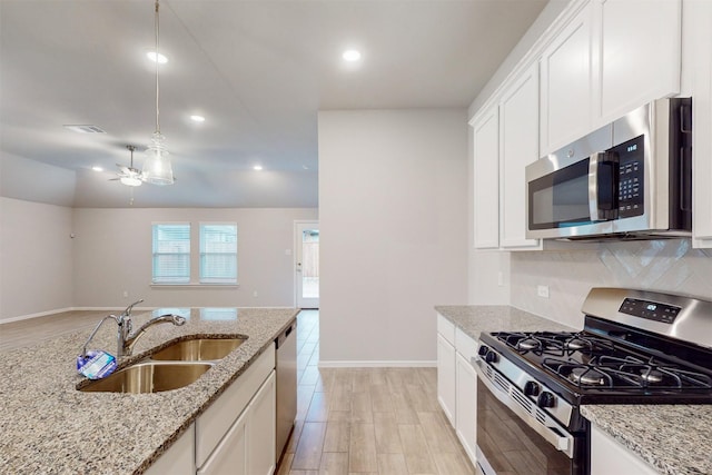 kitchen featuring stainless steel appliances, white cabinetry, and sink