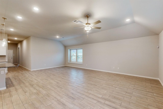 unfurnished living room featuring ceiling fan, lofted ceiling, and light hardwood / wood-style floors