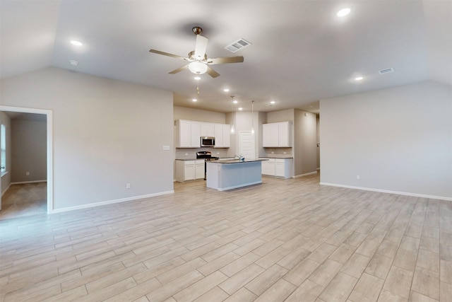 unfurnished living room featuring lofted ceiling, light wood-type flooring, and ceiling fan