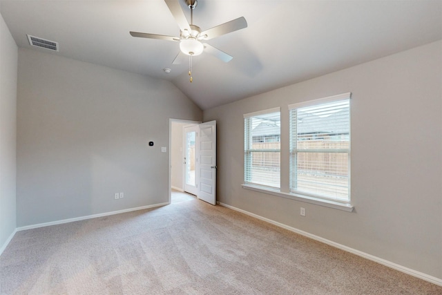 unfurnished room with lofted ceiling, light colored carpet, and ceiling fan