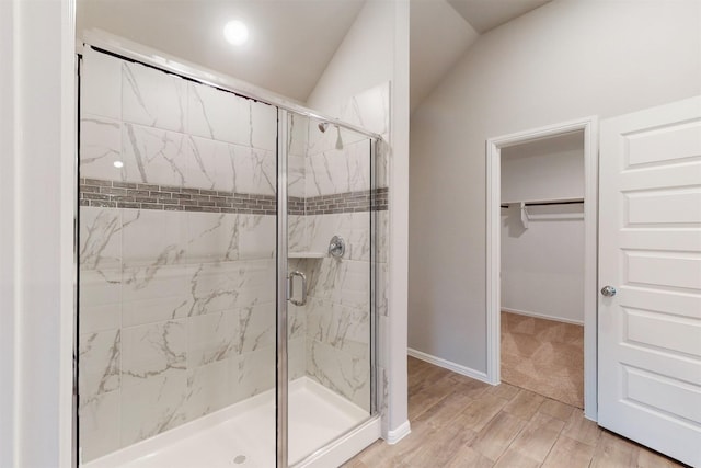 bathroom featuring walk in shower and wood-type flooring