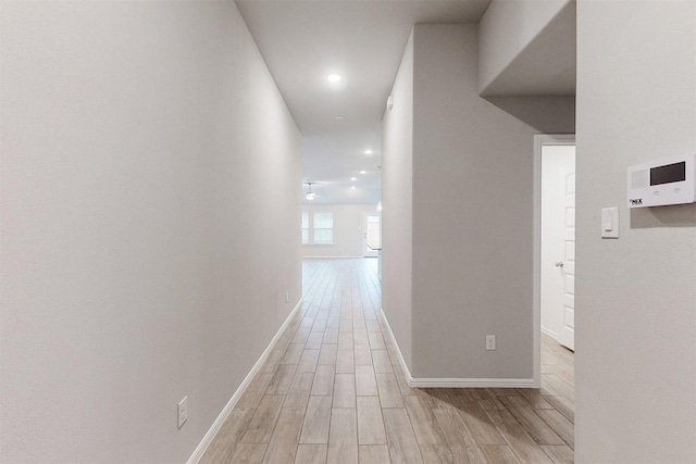 corridor with light hardwood / wood-style floors