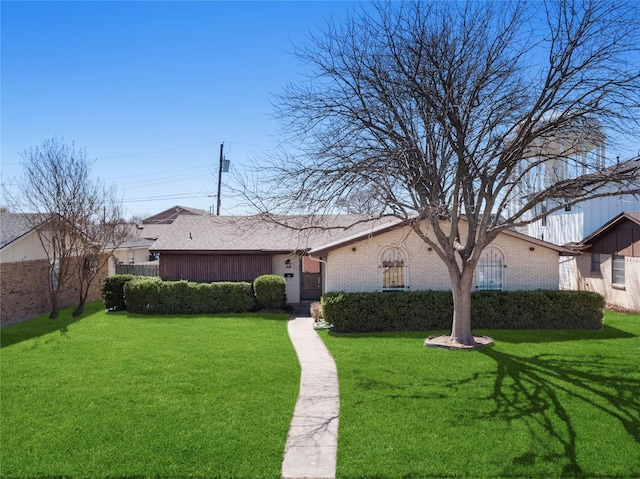 view of front of house with a front lawn and brick siding