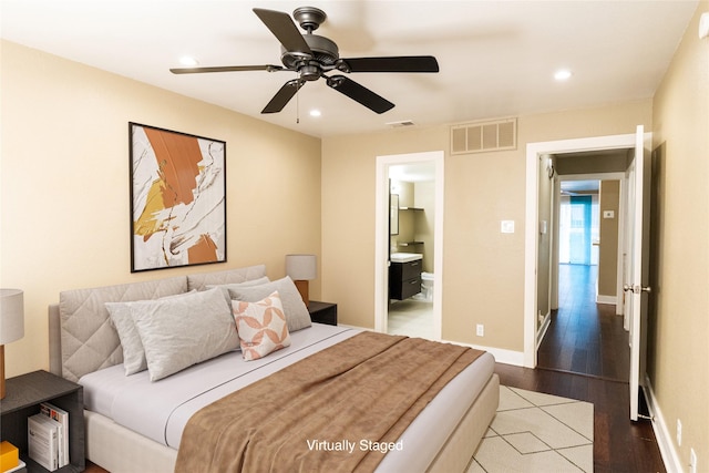 bedroom featuring ensuite bathroom, ceiling fan, and light wood-type flooring