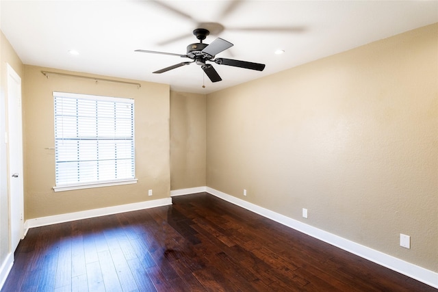 spare room featuring ceiling fan and dark hardwood / wood-style floors