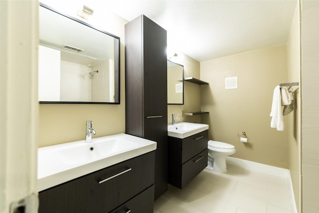 bathroom featuring vanity, tile patterned flooring, and toilet