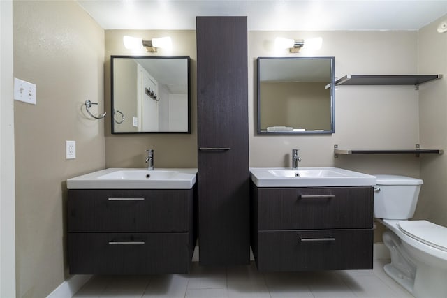 bathroom with vanity, tile patterned floors, and toilet