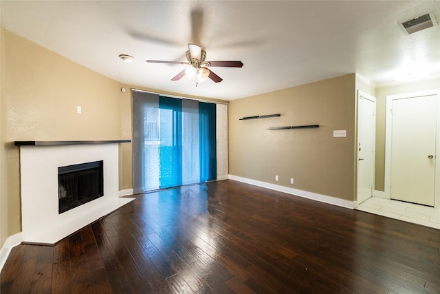 unfurnished living room with hardwood / wood-style flooring and ceiling fan