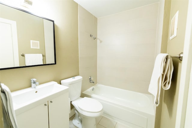 full bathroom with tiled shower / bath, vanity, and toilet