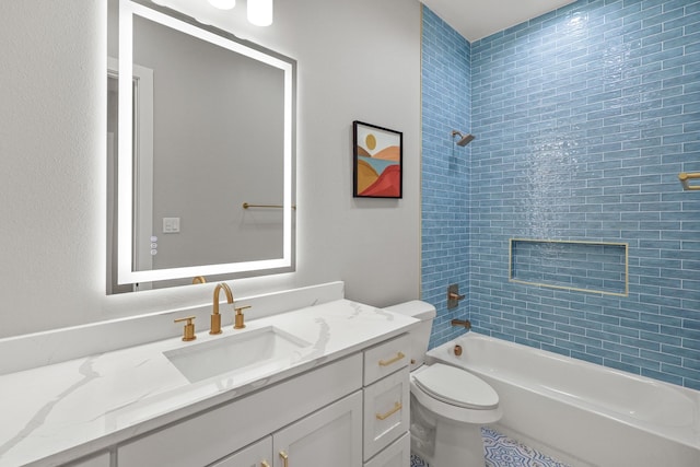 full bathroom featuring tiled shower / bath, vanity, and toilet